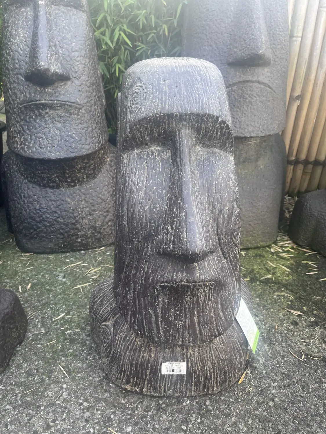 Product image 1 of the product “Moai head as planter, structure of surface in wood optic. 40 x 35 x 64cm. Stone cast, handcrafted & coloured ”